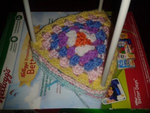 stretching pastel wool granny squares