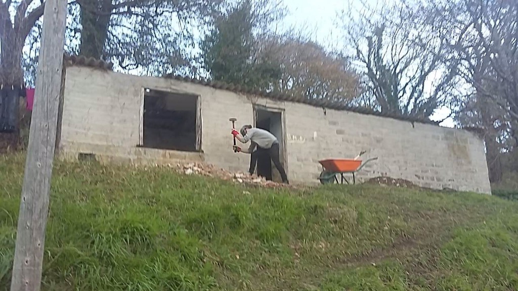Self sufficiency landscaping hammering bricks to dust
