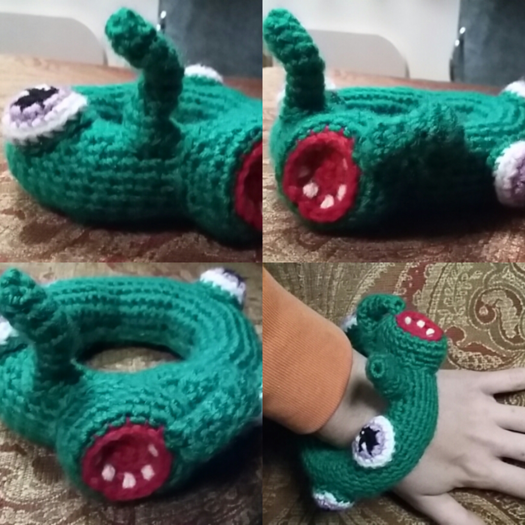 crocheted googley-eyed open mouthed toothed monster